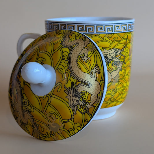 Ceramic cup with dragon design on a beige background