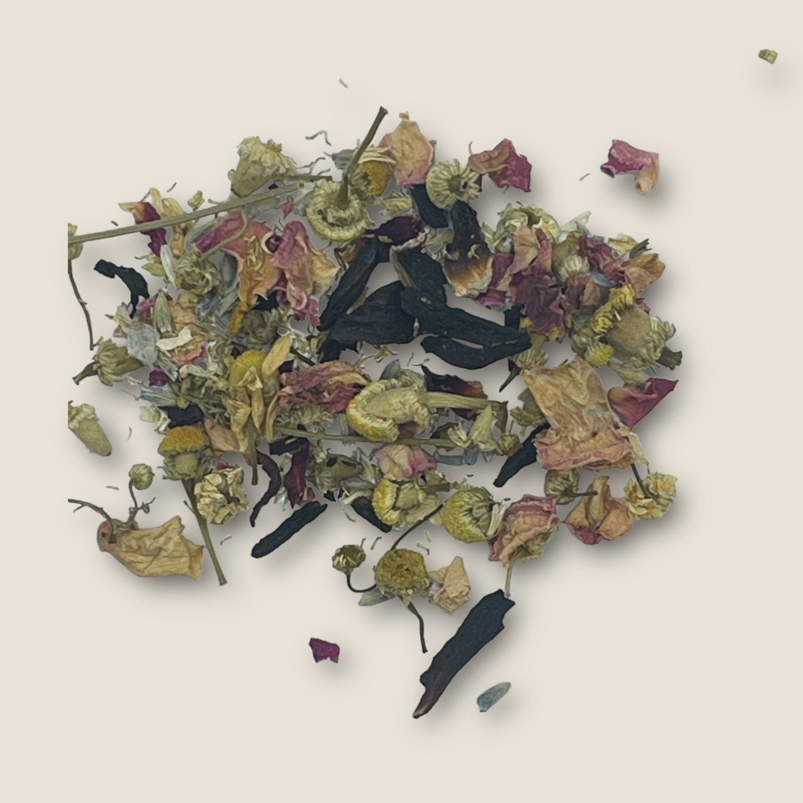 A pile of Lovers Hypnotised from My Store, known for its antioxidants and sleep aid properties, consists of dried chamomile flowers, green stems, and scattered pink rose petals against a neutral background. The ingredients are various shades of green, yellow, and pink.