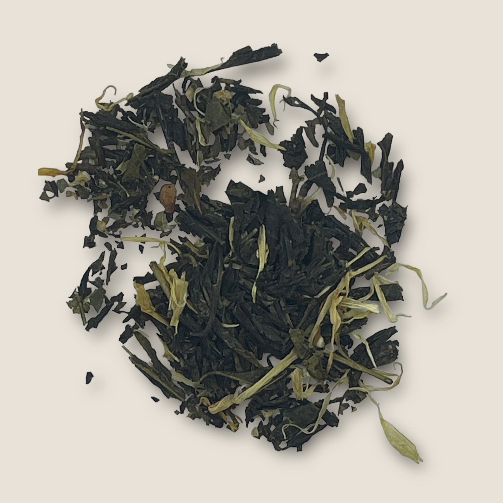 Apple Mojito, a loose leaf green tea from My Store known for its antioxidants and immune support, is blended with dried leaves and flower petals on a light beige background. The tea leaves are dark green and slightly curled, interspersed with light green and yellowish petals, creating a contrast in color and texture.