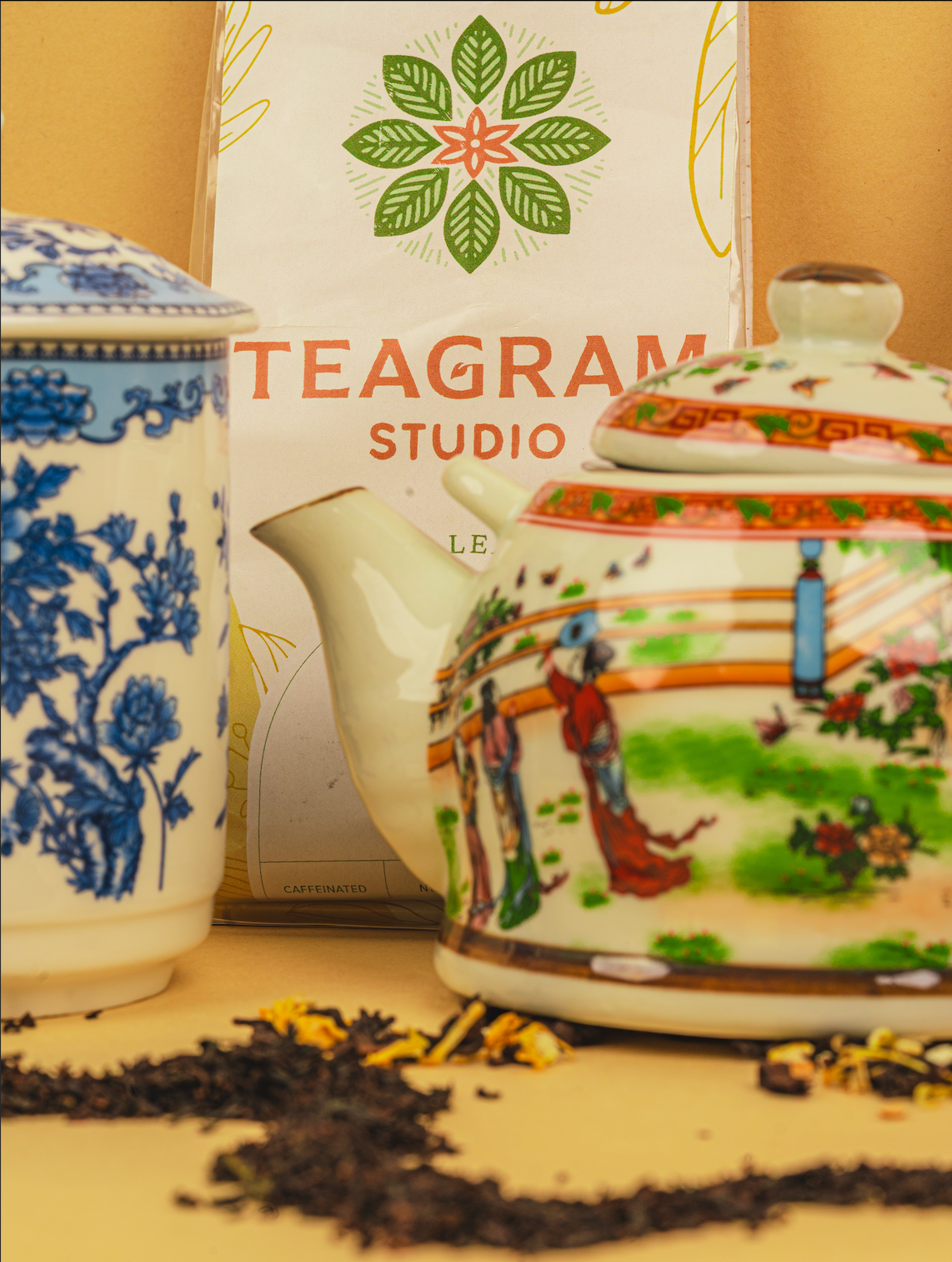 Decorative teapots with intricate designs in front of a 'Telegram Studio' branded box.
