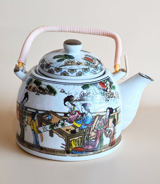 Decorative teapot with colorful scenes on a plain background