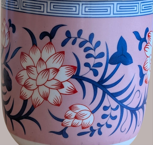 Ceramic jar with floral design on a pink background