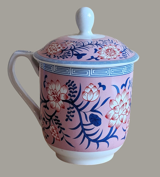 Ceramic mug with floral design on a pink background