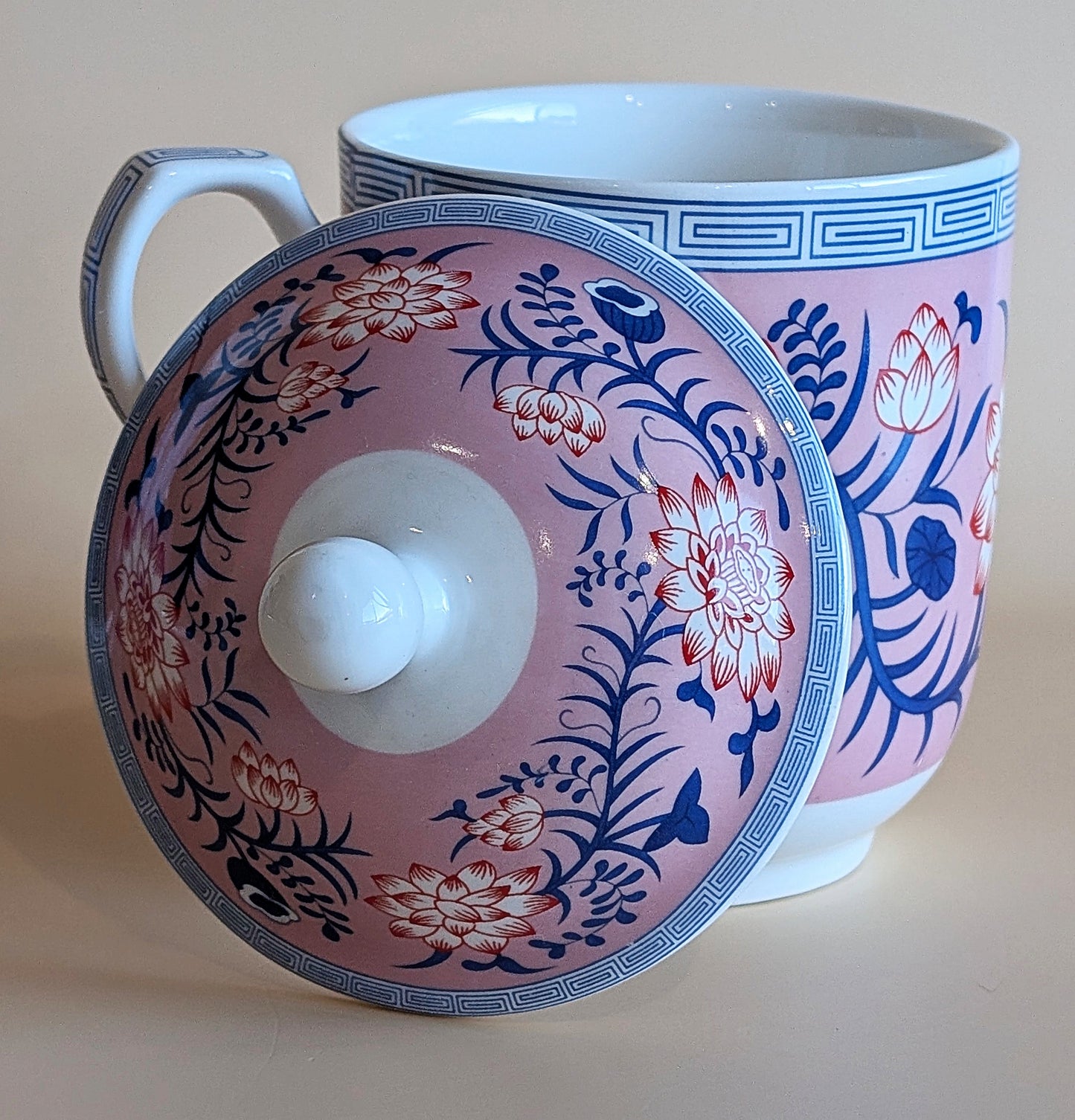 Ceramic mug with floral design on a plain background