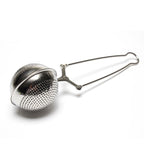 The My Store Easy Grip & Steep Infuser is a stainless steel tea infuser featuring a perforated spherical compartment and a long handle. The handle includes an easy grip clasp mechanism for opening and closing the two halves of the spherical compartment. This dishwasher-safe tea strainer is designed to steep loose tea leaves in hot water.