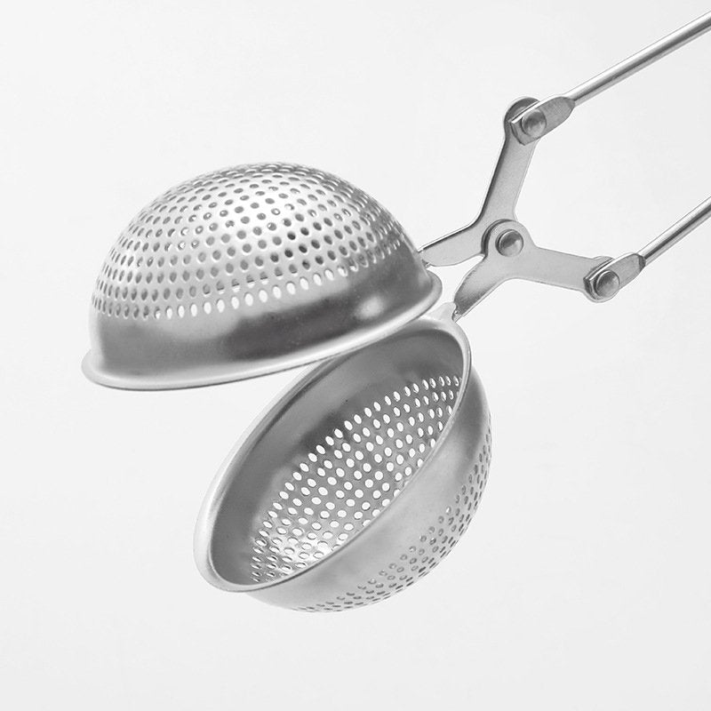 The Easy Grip & Steep Infuser by My Store is a stainless steel tea infuser with a spherical design, featuring two perforated hemispheres connected by a hinge. This dishwasher safe device has scissor-like handles for easy opening and closing, designed for steeping loose leaf tea in hot water.